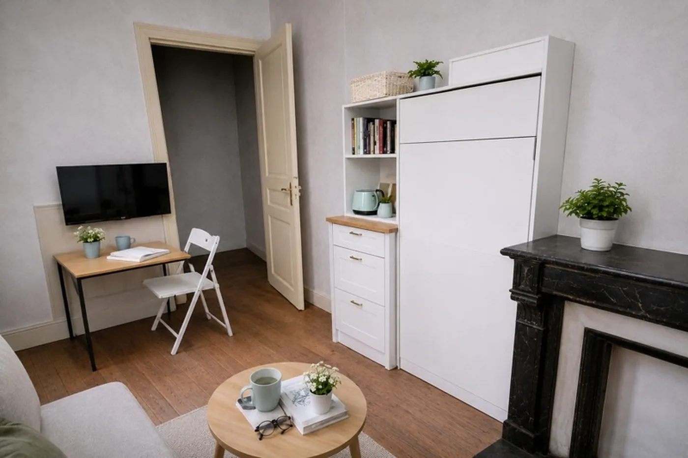 Pièce de vie du studio avec aménagement projeté : lit escamotable, rangements et bureau